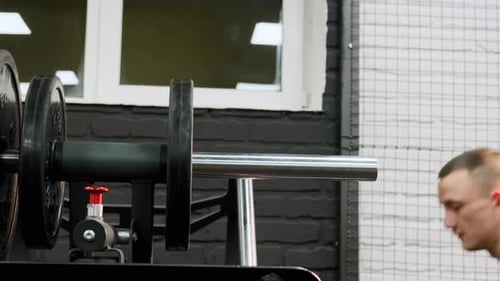 Fit Man Set Weight for Training Barbells in Gym
