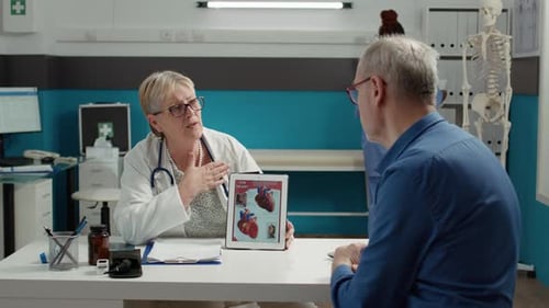Doctor Explains Heart to Patient in Medical Office