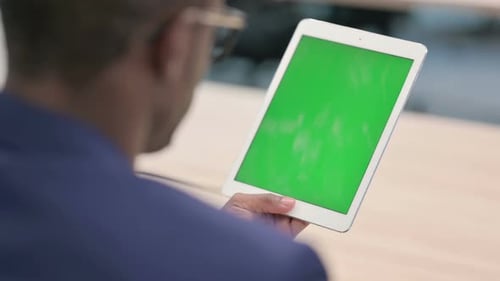 Rear View of Young Businessman Using Tablet with Chroma Screen