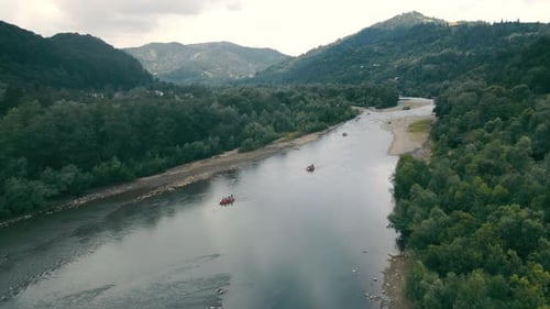 Luftaufnahme von der Spitze der Berglandschaft und des Gebirgsflusses, auf dem Boote fahren