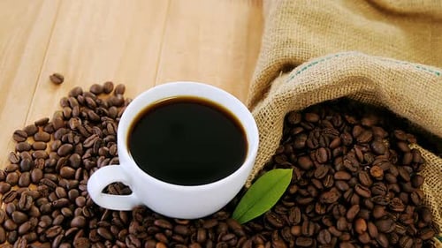 Cup of Black Coffee with Roasted Coffee Beans