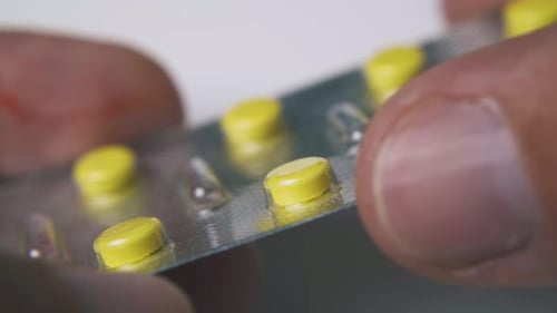 Close up view of yellow pills in blister pack