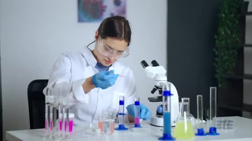 Young Woman Scientist Conducting Experiment in Laboratory