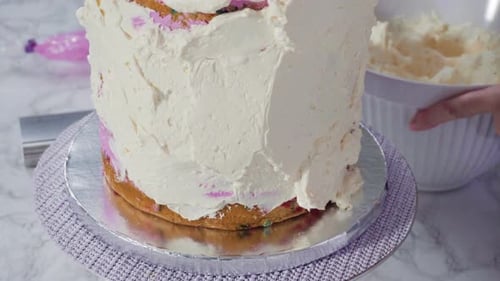 Time lapse. Step by step. Frosting round funfetti cake with white italian buttercream frosting