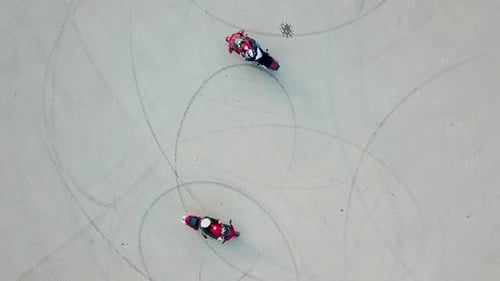 Top view of two professional motobikers racing highspeed on a road in a circle way.