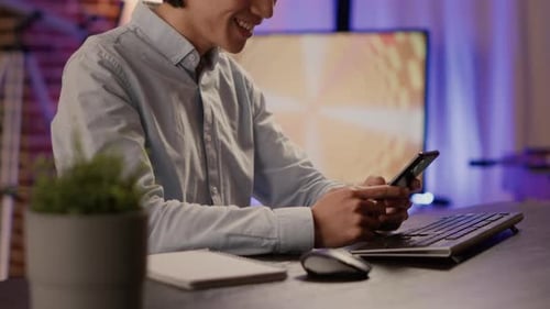 Male Freelancer Using Smartphone on Break to Text Messages