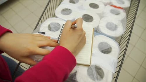 Female Checking Her Shopping List in Supermarket