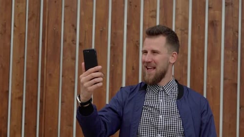 Man Video Calling Smiling and Talking Outside