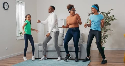 Happy Family Dancing Together in Living Room