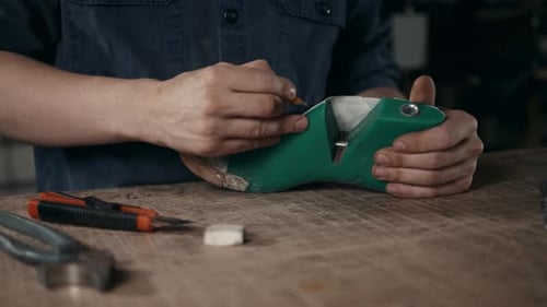 Craftsman Marking a Shoe Form in Studio