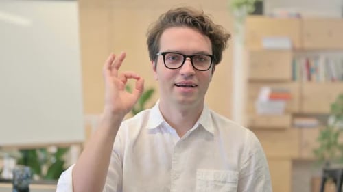 Smiling Man Giving OK Hand Gesture