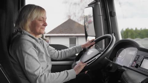 Woman Driving a Truck on a Daytime Route