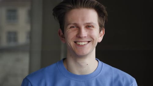 Closeup Male Smiling Face of Caucasian 25s Guy Posing at Home