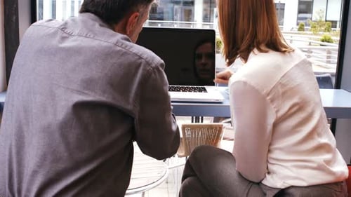 Coworkers Working on Computer in Office Environment