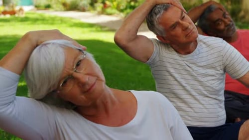 Senior friends doing exercise in garden 4k