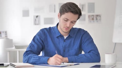 Casual Adult Man Writing in Office