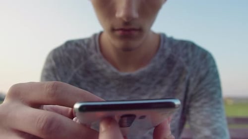 Young Adult Using Smartphone Outdoors