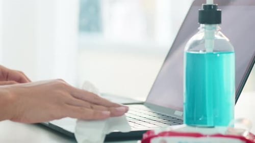 Hands Cleaning Laptop with Antiseptic Wipe