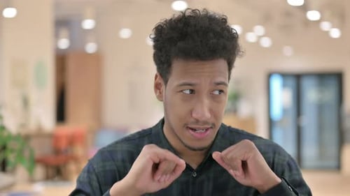 Young Adult Explains Something and Waves to Camera