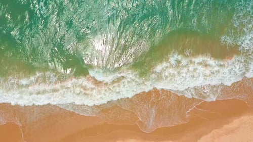 Aerial View. Waves Break on White Sand Beach. Sea Waves on the Beautiful Beach.