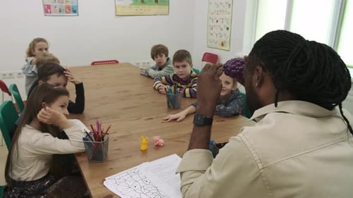 Teacher Teaches Students in a Classroom Setting
