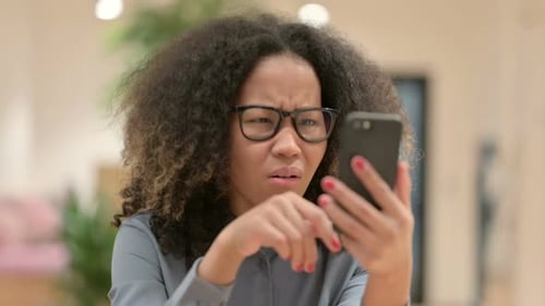 Woman With Mobile Phone Looking Frustrated