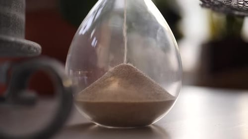 Close Up of Sand Falling Through Hourglass
