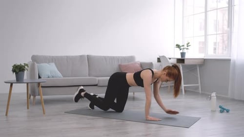 Woman Exercising on a Mat at Home