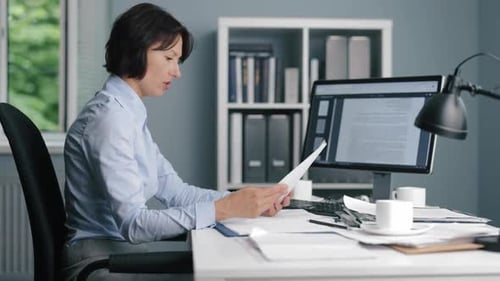 Stressed Woman at Desk in Office Workplace