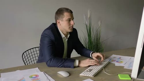 Man Working at Computer in Modern Office