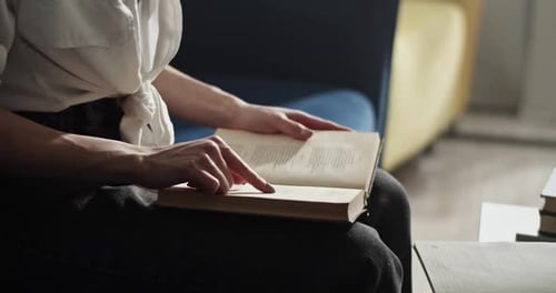 Woman Reading Book Indoors at Home