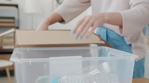 Woman Sorting Recyclable Items into Plastic Bin