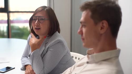 Tracking Shot of Happy Asian Business Woman and Caucasian Man Sitting Office Table Discussing Ideas