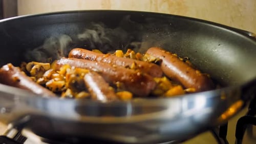 Sausages Frying with Onions and Mushrooms