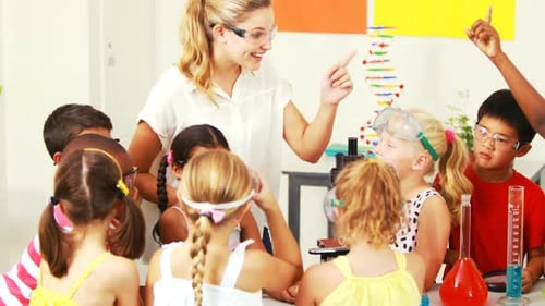 Teacher assisting kids in laboratory