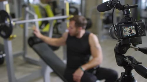 Gym Coach Explaining Barbell Exercise on Camera