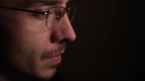 Man Wearing Glasses in Low Light, Close Up