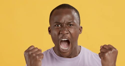Man Shouting in Anger on Yellow Background