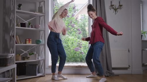 Two Young Women Dancing by the Window