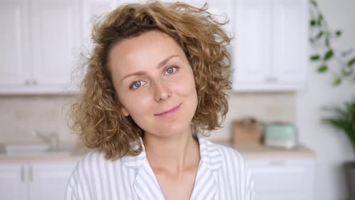 Woman with Curly Hair Smiling in Home