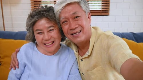 Happy Senior Couple Waving on a Video Call