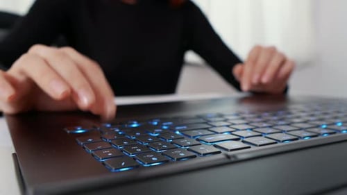 Woman Typing On A Laptop