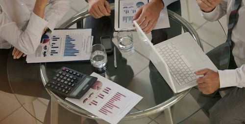 Business Team Reviewing Financial Data at Meeting