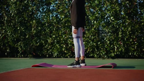 Woman Exercising Outdoors With Resistance Band