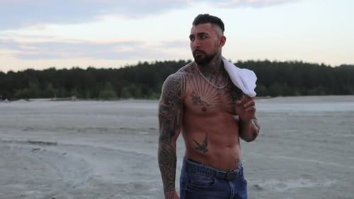 Muscular Man Poses in Desert Landscape