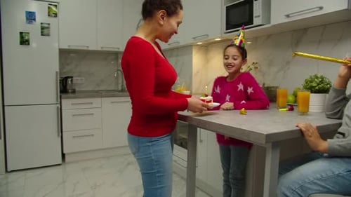 Family Celebrates Child's Birthday With Cake and Party