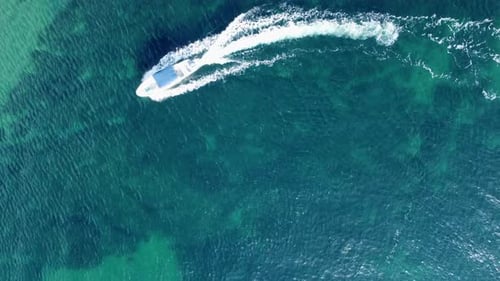 Speedboat Cruising in Turquoise Ocean Water Aerial View