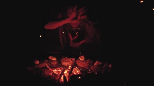 Scary Witch Does Voodoo Black Magic Ritual Near the Fire at Night