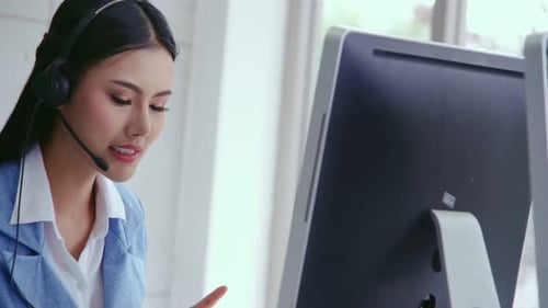 Customer Support Agent or Call Center with Headset Talking to Customer on Phone