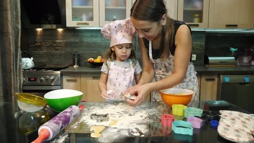 Woman and Child Baking Cookies at Home